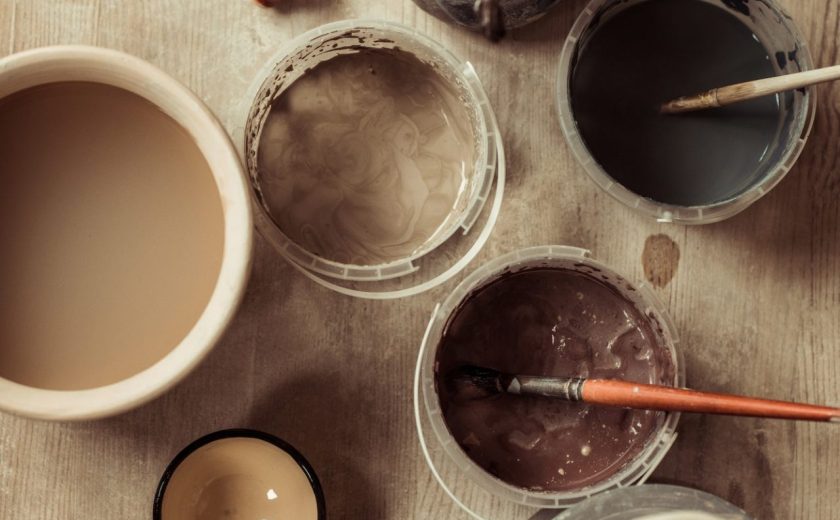 close-up-of-paint-brushes-with-pottery-tools-in-bowls-on-table.jpg